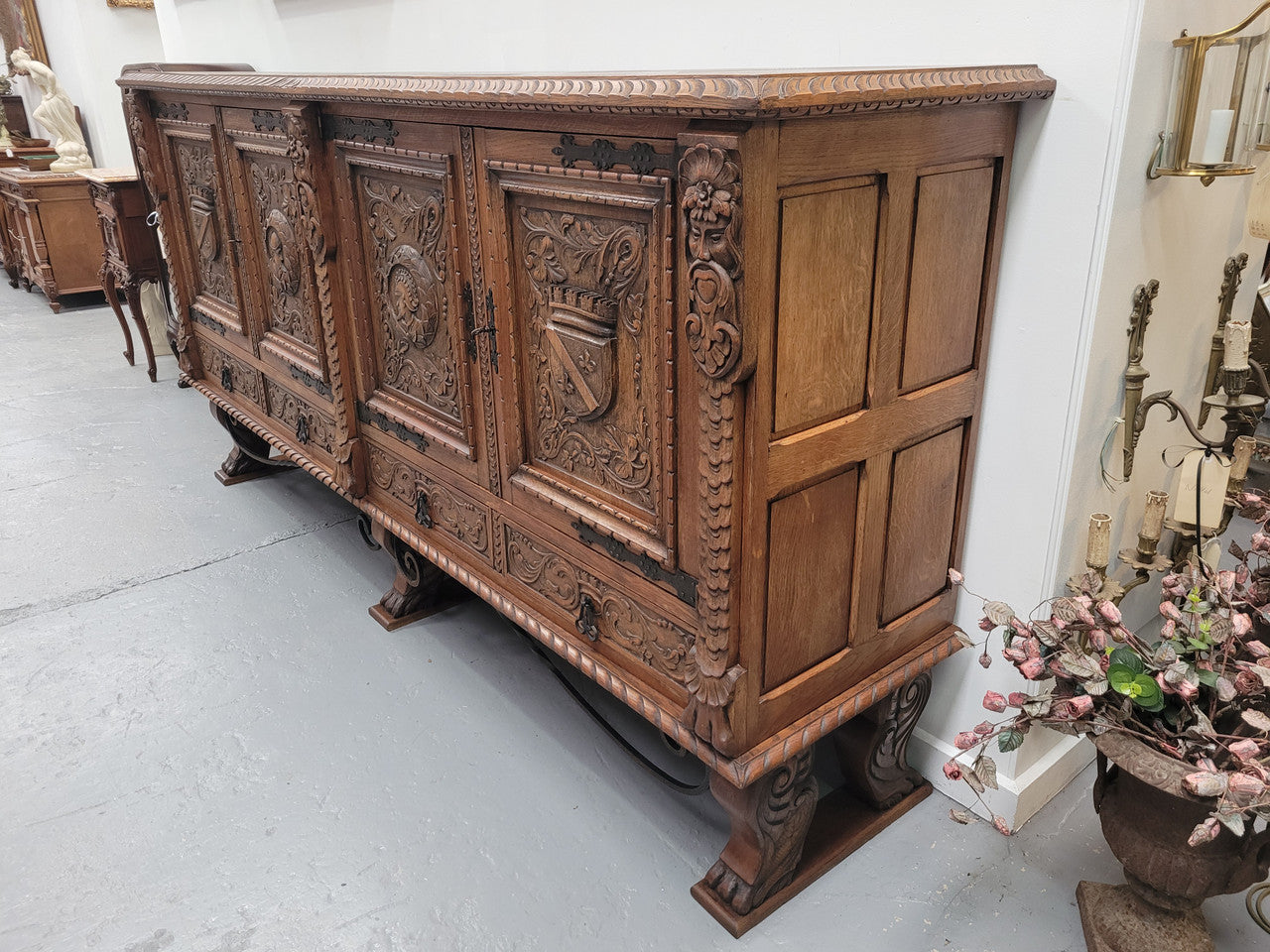 Large French Oak Renaissance style four door sideboard/buffet. Great decorative item with amazing carvings and stunning iron work on base. It is in good original detailed condition. Can pull apart completely making it easier to move.
