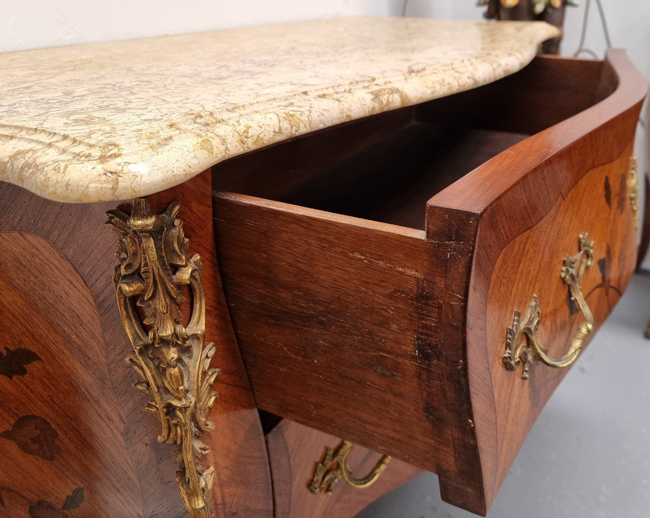 Louis XV style marquetry inlay marble top two drawer commode. It has decorative ormolu mounts and beautiful marble top. In good original detailed condition and has been sourced from France.