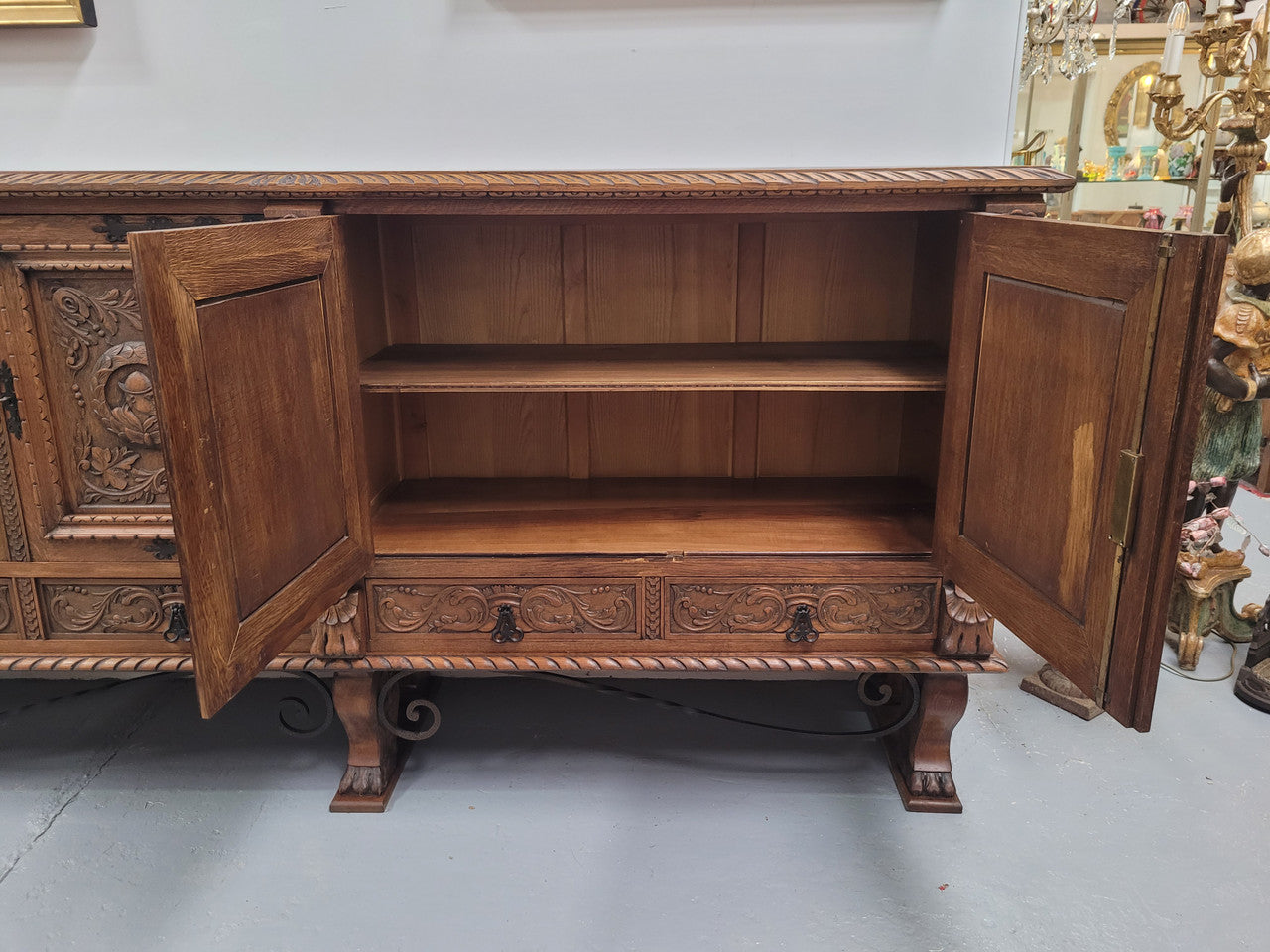 Large French Oak Renaissance style four door sideboard/buffet. Great decorative item with amazing carvings and stunning iron work on base. It is in good original detailed condition. Can pull apart completely making it easier to move.