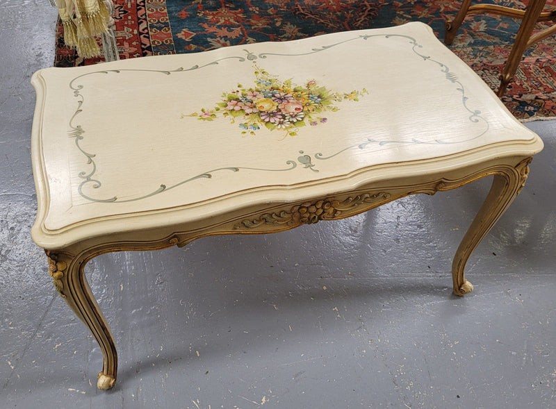 Delightful Vintage French Louis 15th style coffee table with original painted floral centerpiece and gilded highlights. It has been sourced from France and are in good original condition.