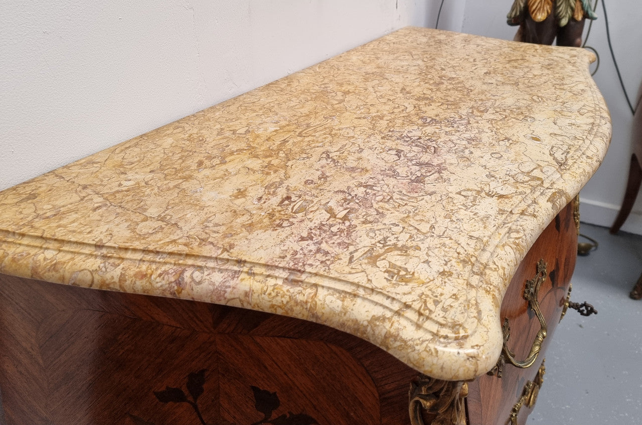 Louis XV style marquetry inlay marble top two drawer commode. It has decorative ormolu mounts and beautiful marble top. In good original detailed condition and has been sourced from France.