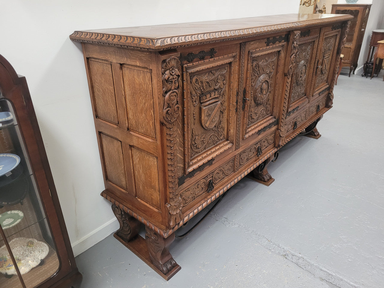 Large French Oak Renaissance style four door sideboard/buffet. Great decorative item with amazing carvings and stunning iron work on base. It is in good original detailed condition. Can pull apart completely making it easier to move.