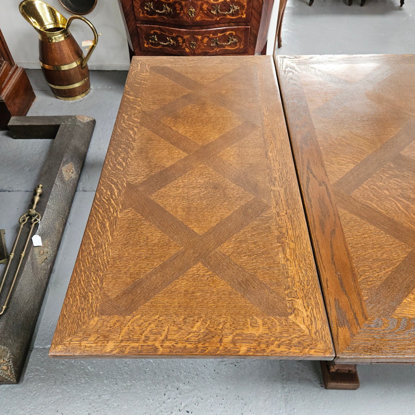 Beautiful French Oak Spanish style extension dining table with a decorative iron base and parquetry top. Lovely carvings on the legs and the skirt of the base. With the extensions closed it is 179.5 cm long and when fully extended it is 279 cm long.