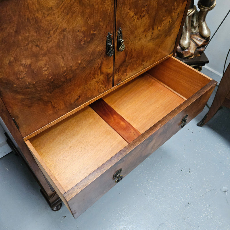 Lovely figured walnut Antique cabinet with a two door cabinet and two drawers. Circa 1930s. This cabinet can be used as a regular cabinet, drinks cabinet or tv unit as it has the hole for cables at the back. It is in good original detailed condition.