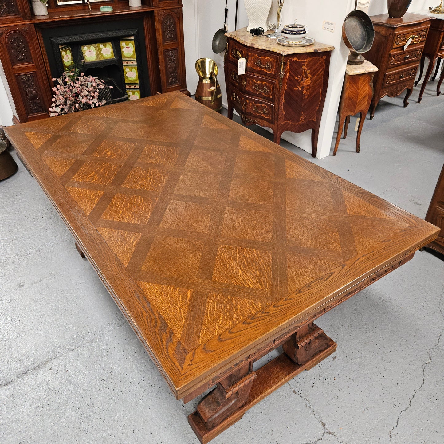 Beautiful French Oak Spanish style extension dining table with a decorative iron base and parquetry top. Lovely carvings on the legs and the skirt of the base. With the extensions closed it is 179.5 cm long and when fully extended it is 279 cm long.