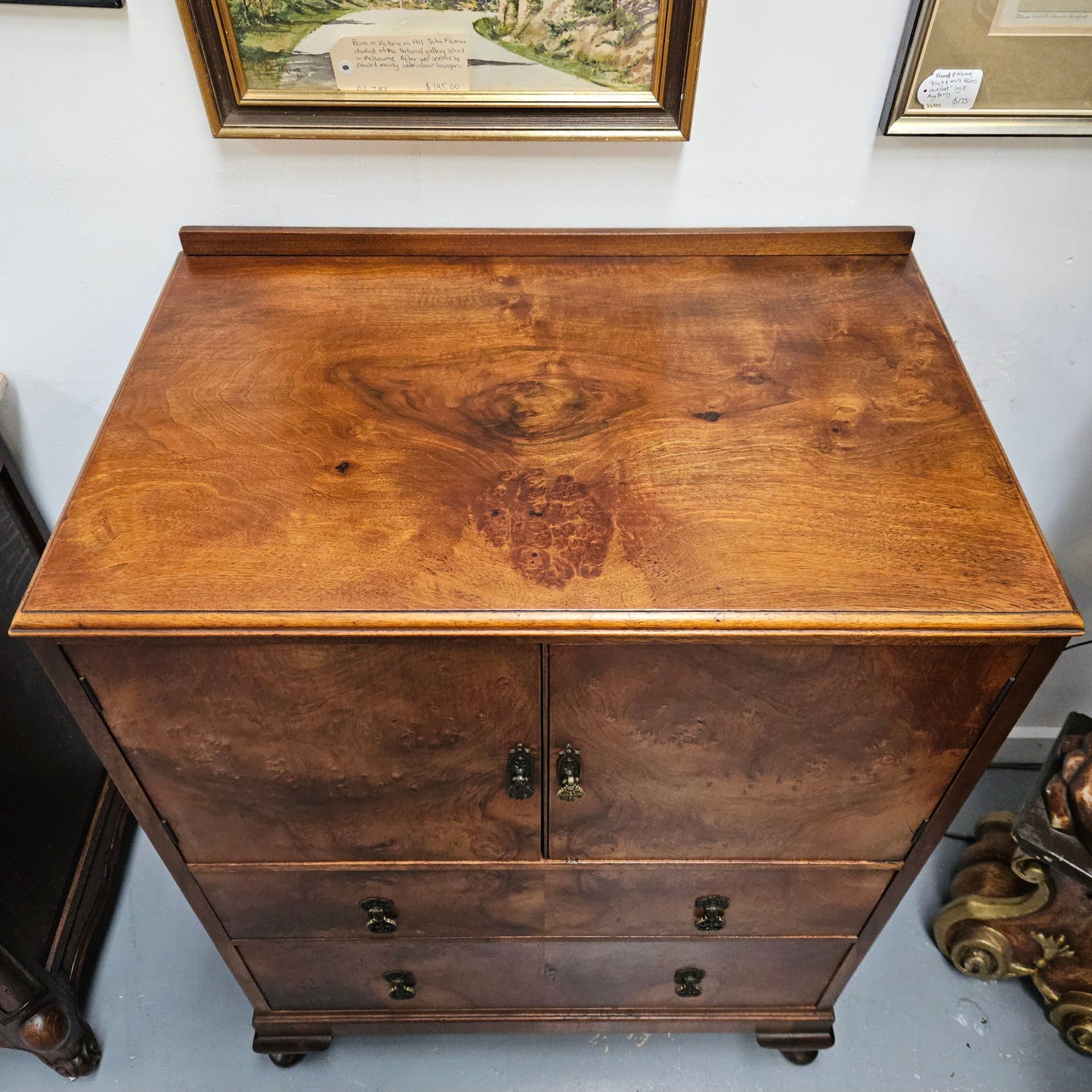 Lovely figured walnut Antique cabinet with a two door cabinet and two drawers. Circa 1930s. This cabinet can be used as a regular cabinet, drinks cabinet or tv unit as it has the hole for cables at the back. It is in good original detailed condition.