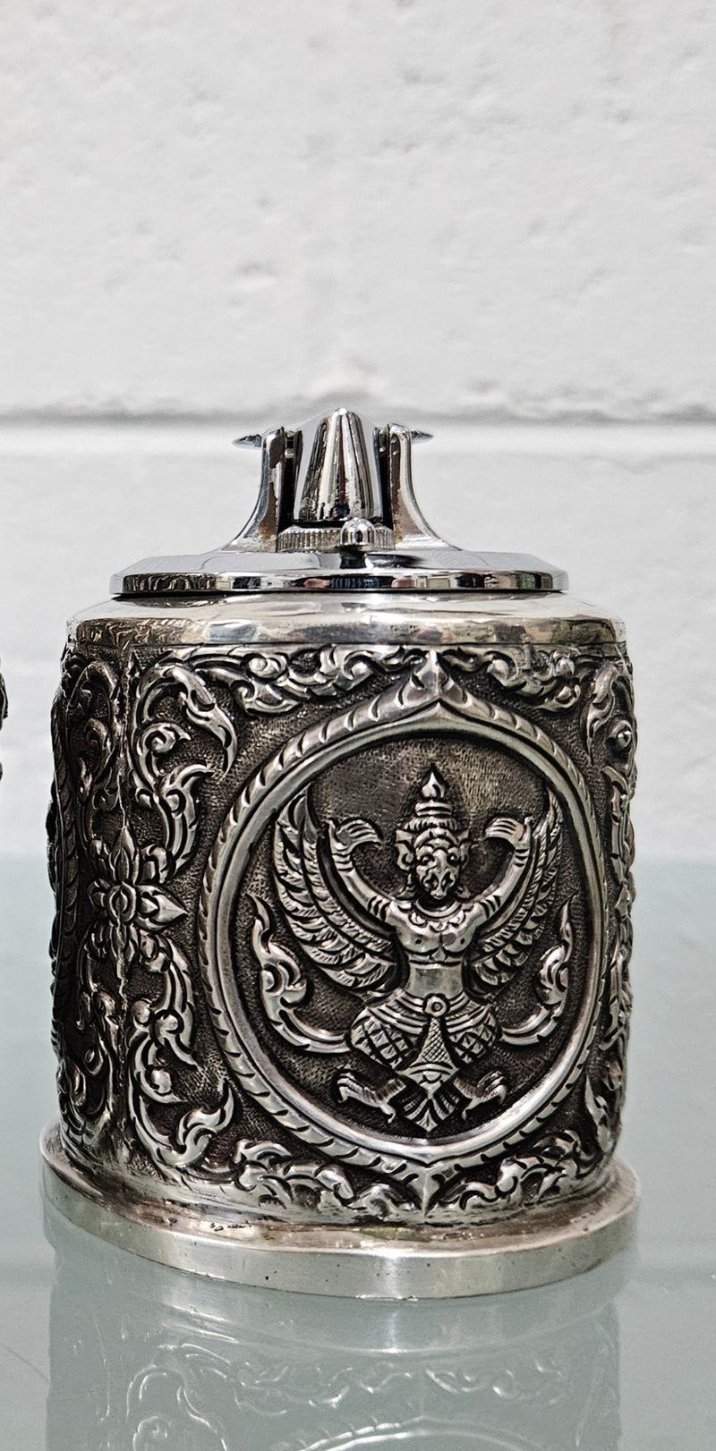 Vintage Siam sterling silver cigarette or small cigar holder and silver cased Ronson lighter. The holder in timber lined and both feature superb repousse worked decoration. The lighter hasn't been tested but it is in good original condition. Please view photos the as they help form part of the description and the condition.   Please note the measurements are for the cigarette holder.  Cigarette Holder: 170gm Lighter: 238gm