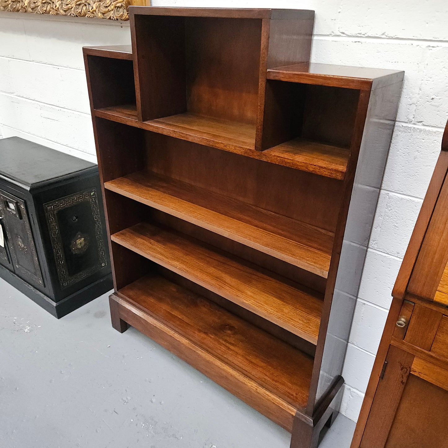 Australian blackwood Arts and Crafts bookcase with two fully adjustable shelves. It has been sourced locally. Made with solid Australian blackwood, this Arts and Crafts bookcase boasts two fully adjustable shelves for versatile storage options. Its good original detail adds a touch of character and charm.