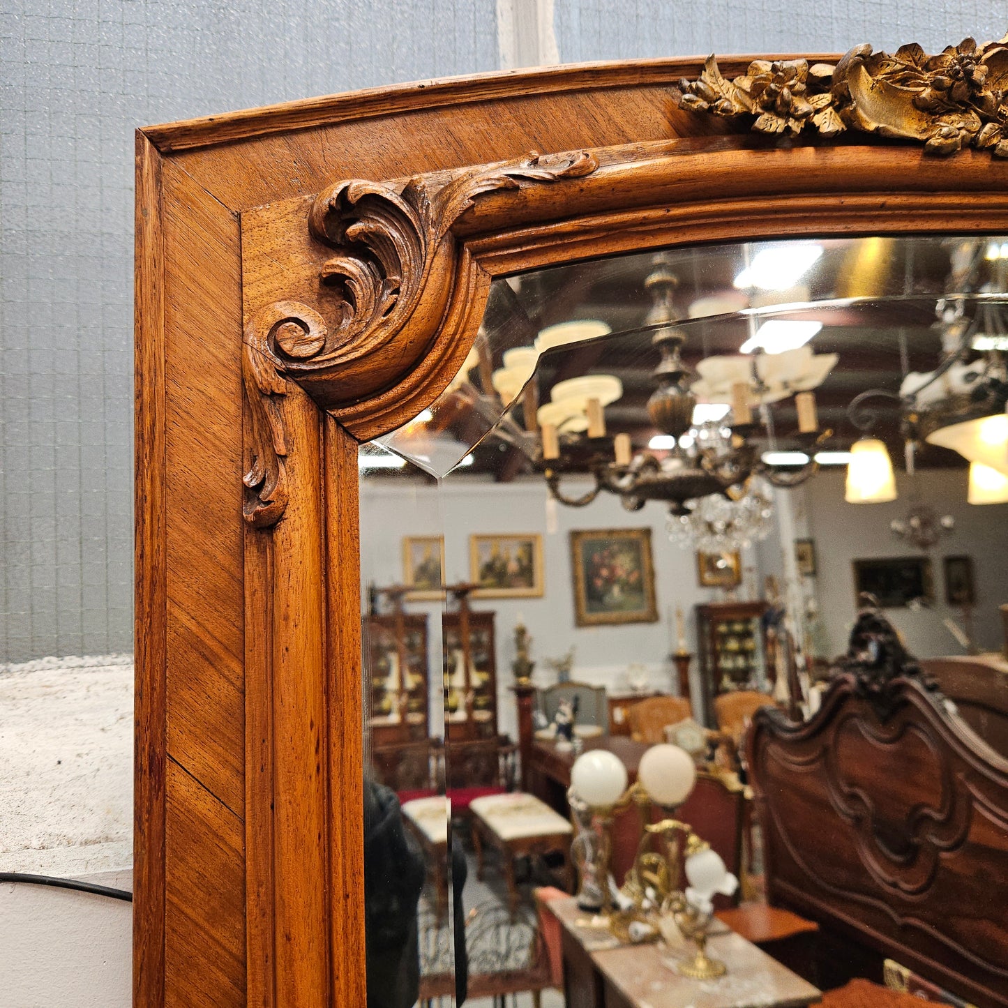 A fabulous tall Louis XV style Walnut floor/mantle mirror featuring decorative bronze gilt ormolu mounts. It still contains its beautiful original bevelled edged mirror. It has been sourced from France and is in good original detailed condition.