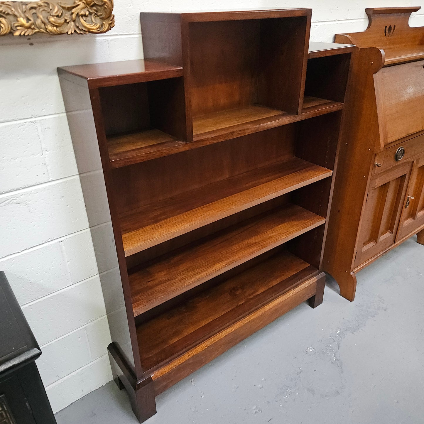 Australian blackwood Arts and Crafts bookcase with two fully adjustable shelves. It has been sourced locally. Made with solid Australian blackwood, this Arts and Crafts bookcase boasts two fully adjustable shelves for versatile storage options. Its good original detail adds a touch of character and charm.