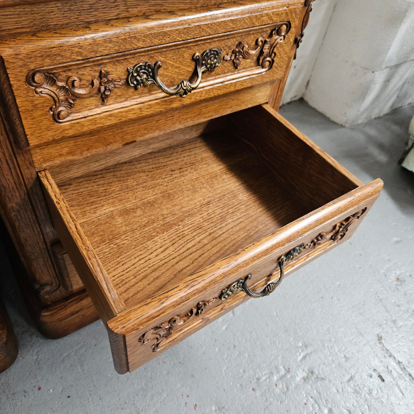 Hard to find Louis XVI style French Oak bedsides with three drawers and lovely carvings. They are in good original detailed condition.