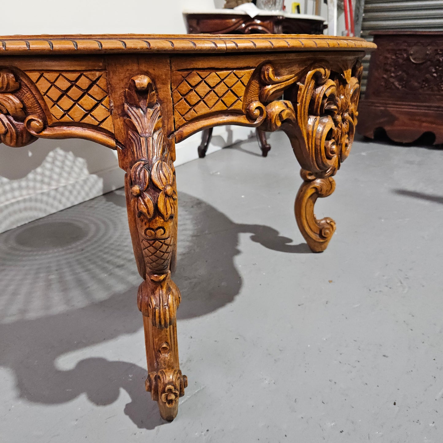 French oak Louis XV style round cane insert coffee table with highly decorative legs and table top. It has a glass cover to fit over the cane. It is in good original condition and has been sourced from France.