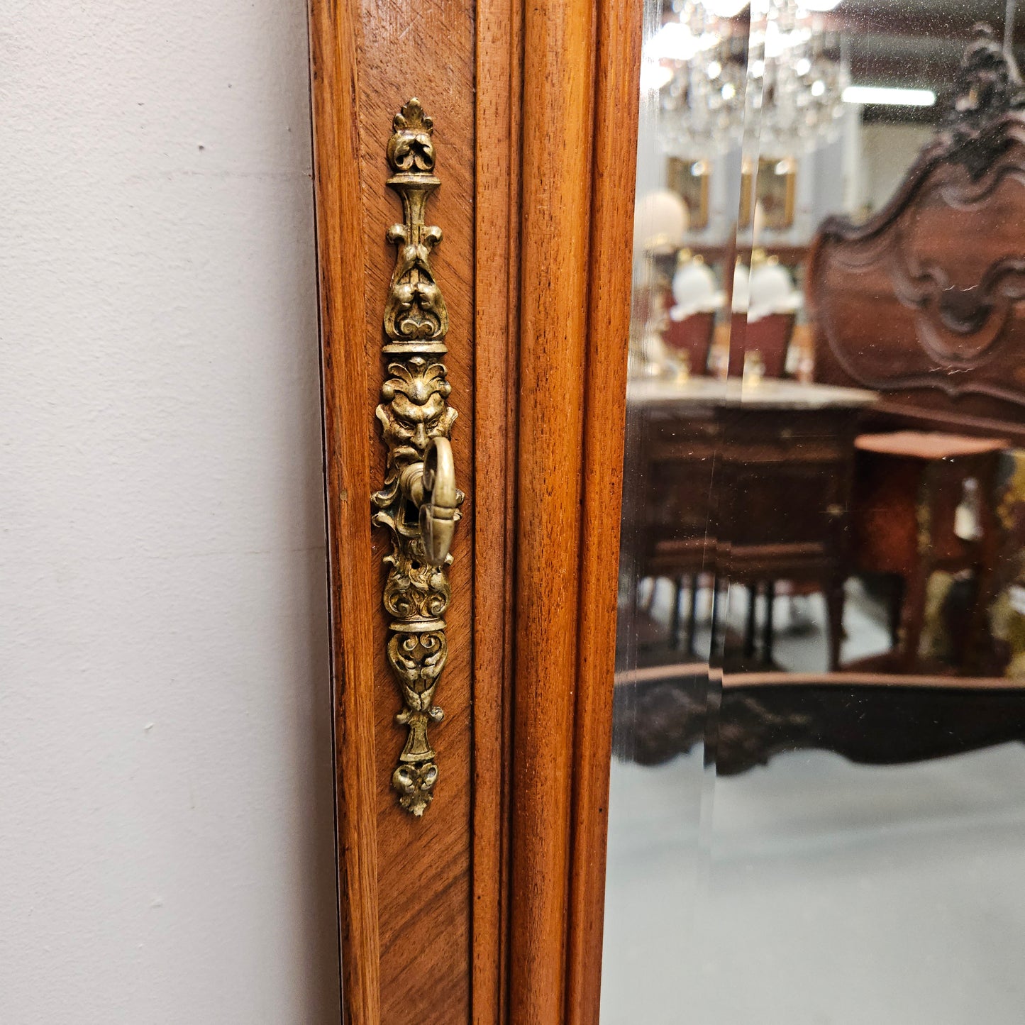 A fabulous tall Louis XV style Walnut floor/mantle mirror featuring decorative bronze gilt ormolu mounts. It still contains its beautiful original bevelled edged mirror. It has been sourced from France and is in good original detailed condition.