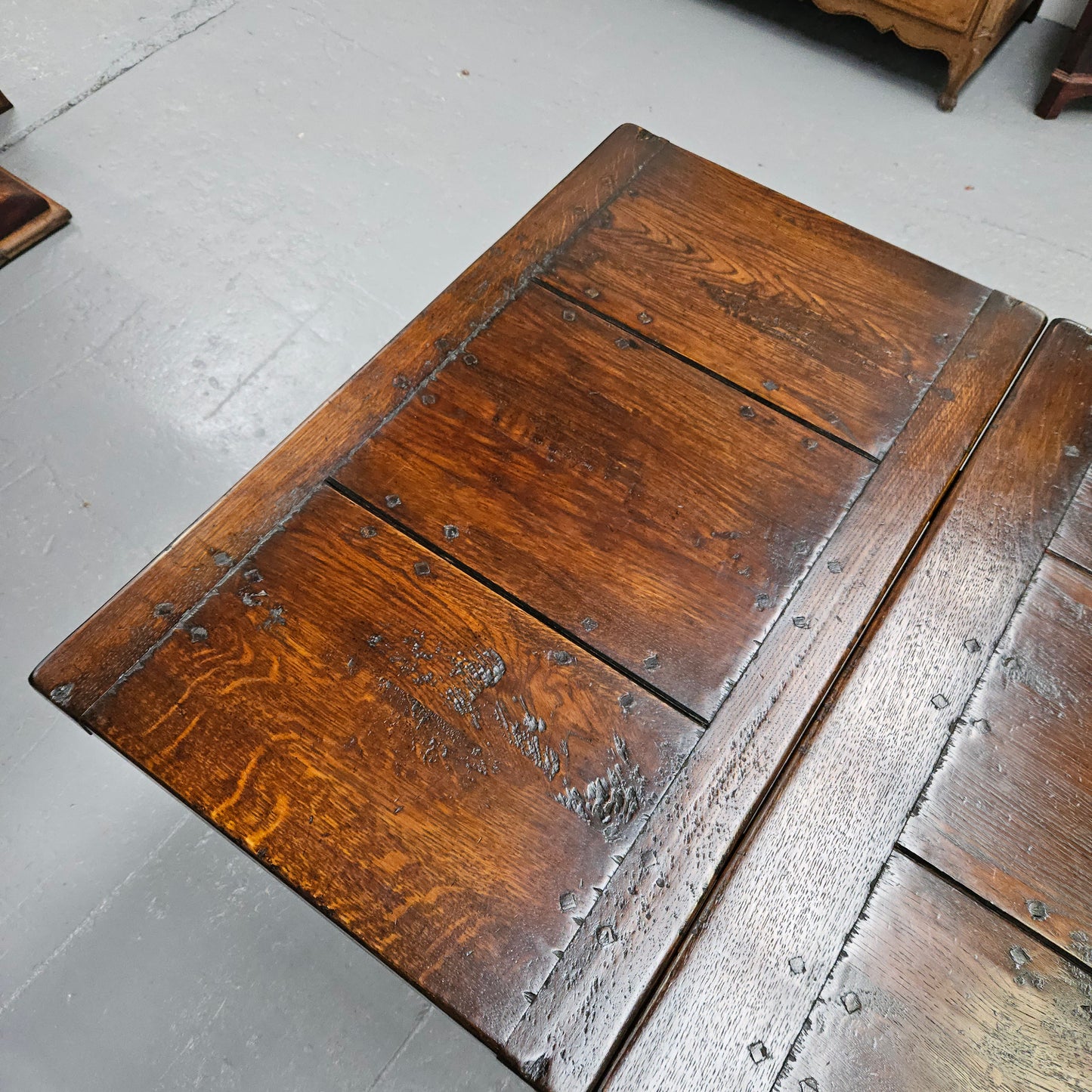 Stunning stretcher base reclaimed antique timbers farmhouse dining table with two extension leaves that can be added to either side. Sourced directly from France and is in good original detailed condition.