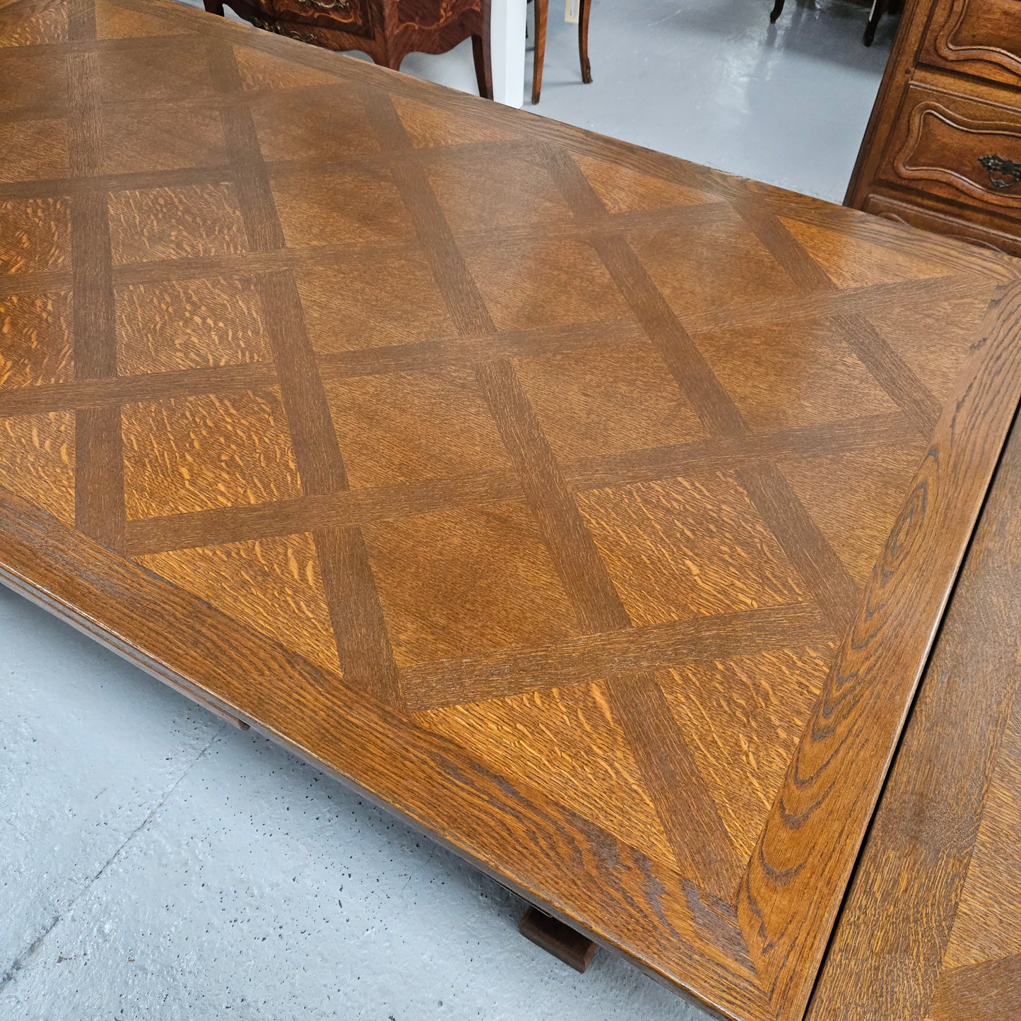 Beautiful French Oak Spanish style extension dining table with a decorative iron base and parquetry top. Lovely carvings on the legs and the skirt of the base. With the extensions closed it is 179.5 cm long and when fully extended it is 279 cm long.