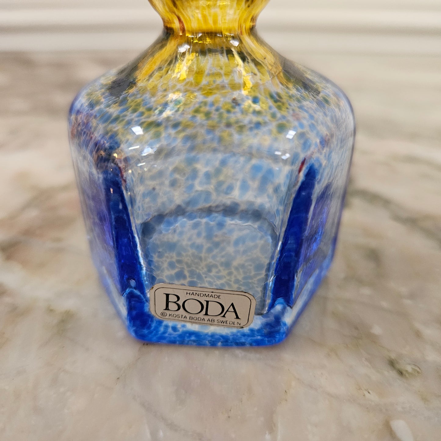 Beautiful yellow and blue Kosta Boda bud vase, with its original sticker. Please view photos as they help form part of the description.