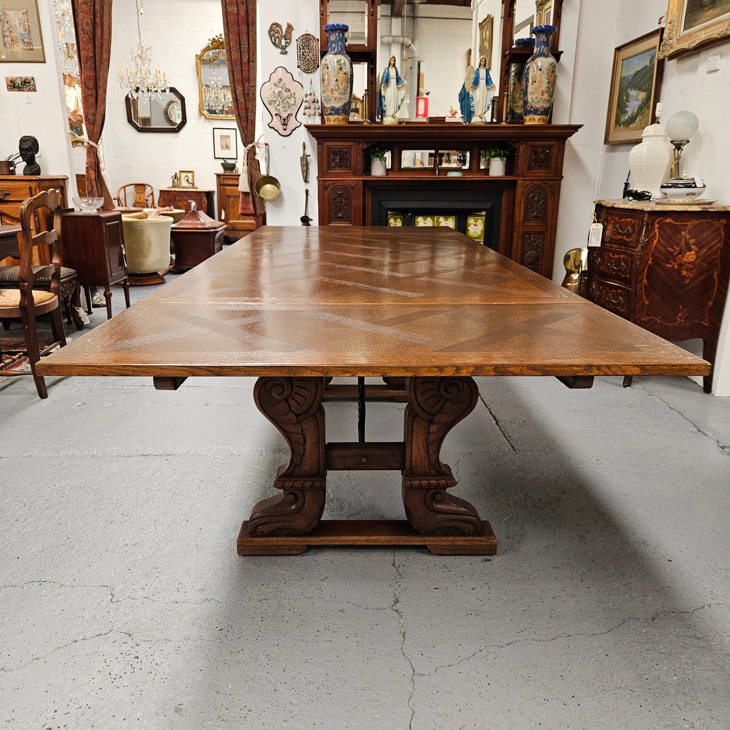 Beautiful French Oak Spanish style extension dining table with a decorative iron base and parquetry top. Lovely carvings on the legs and the skirt of the base. With the extensions closed it is 179.5 cm long and when fully extended it is 279 cm long.