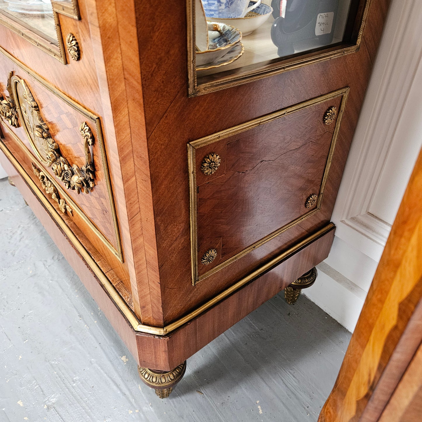 Excellent quality French walnut Louis XVI style vitrine with stunning quality ormolu mounts. It has three shelves in total with two made from glass and the bottom shelf is a wooden shelf that is covered in the same fabric that is on the back of the cabinet. It is in good sympathetically restored condition.