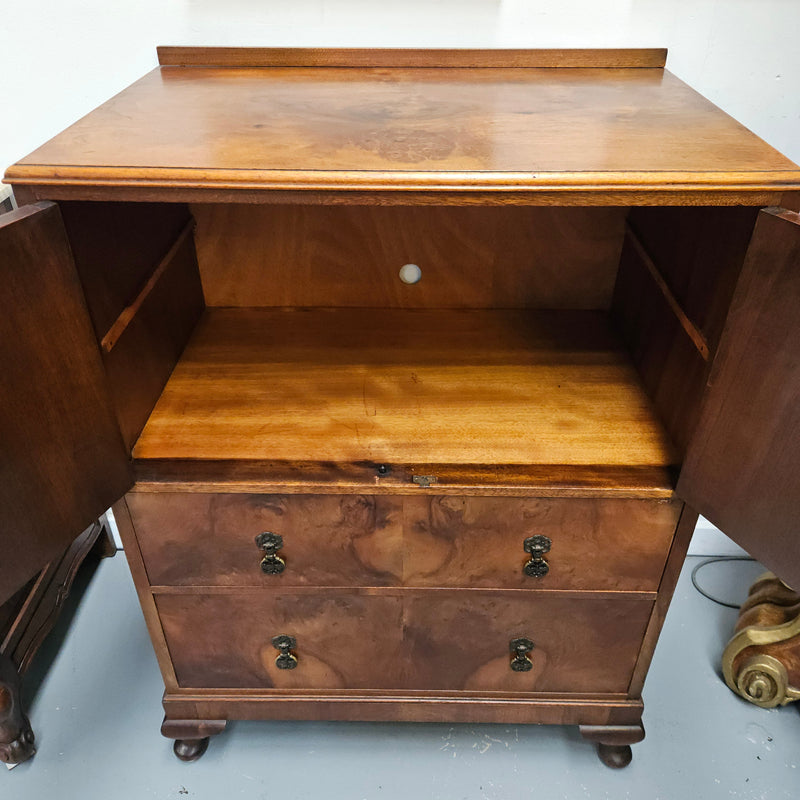 Lovely figured walnut Antique cabinet with a two door cabinet and two drawers. Circa 1930s. This cabinet can be used as a regular cabinet, drinks cabinet or tv unit as it has the hole for cables at the back. It is in good original detailed condition.