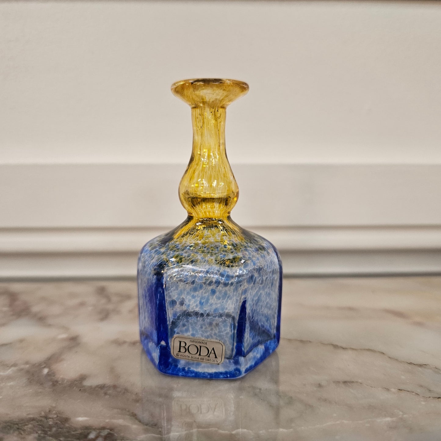 Beautiful yellow and blue Kosta Boda bud vase, with its original sticker. Please view photos as they help form part of the description.