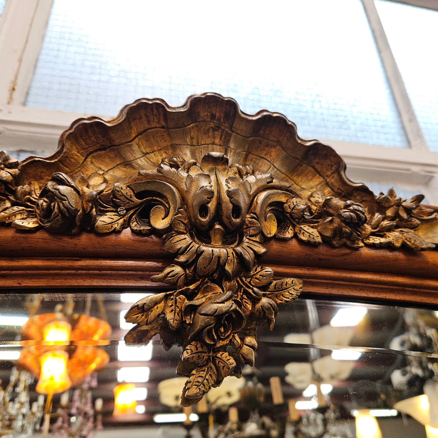 A fabulous tall Louis XV style Walnut floor/mantle mirror featuring decorative bronze gilt ormolu mounts. It still contains its beautiful original bevelled edged mirror. It has been sourced from France and is in good original detailed condition.
