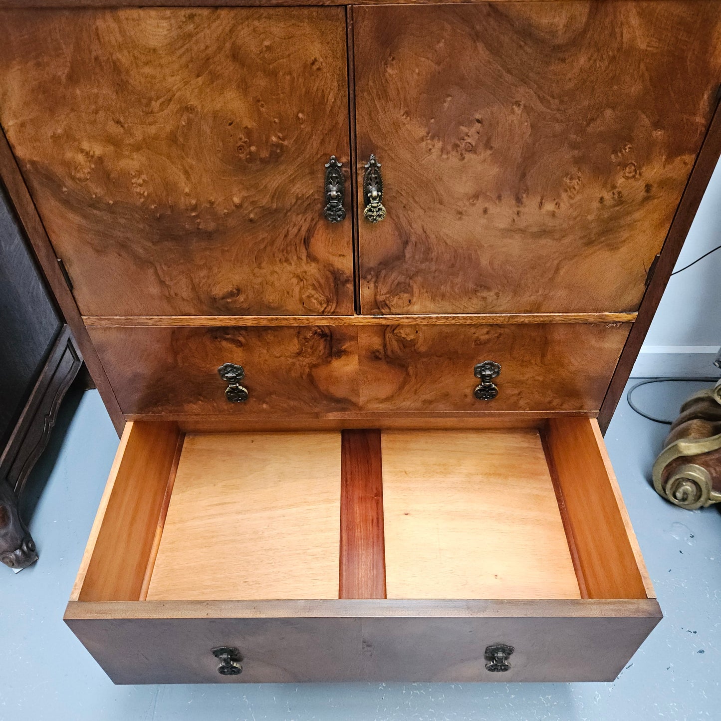 Lovely figured walnut Antique cabinet with a two door cabinet and two drawers. Circa 1930s. This cabinet can be used as a regular cabinet, drinks cabinet or tv unit as it has the hole for cables at the back. It is in good original detailed condition.