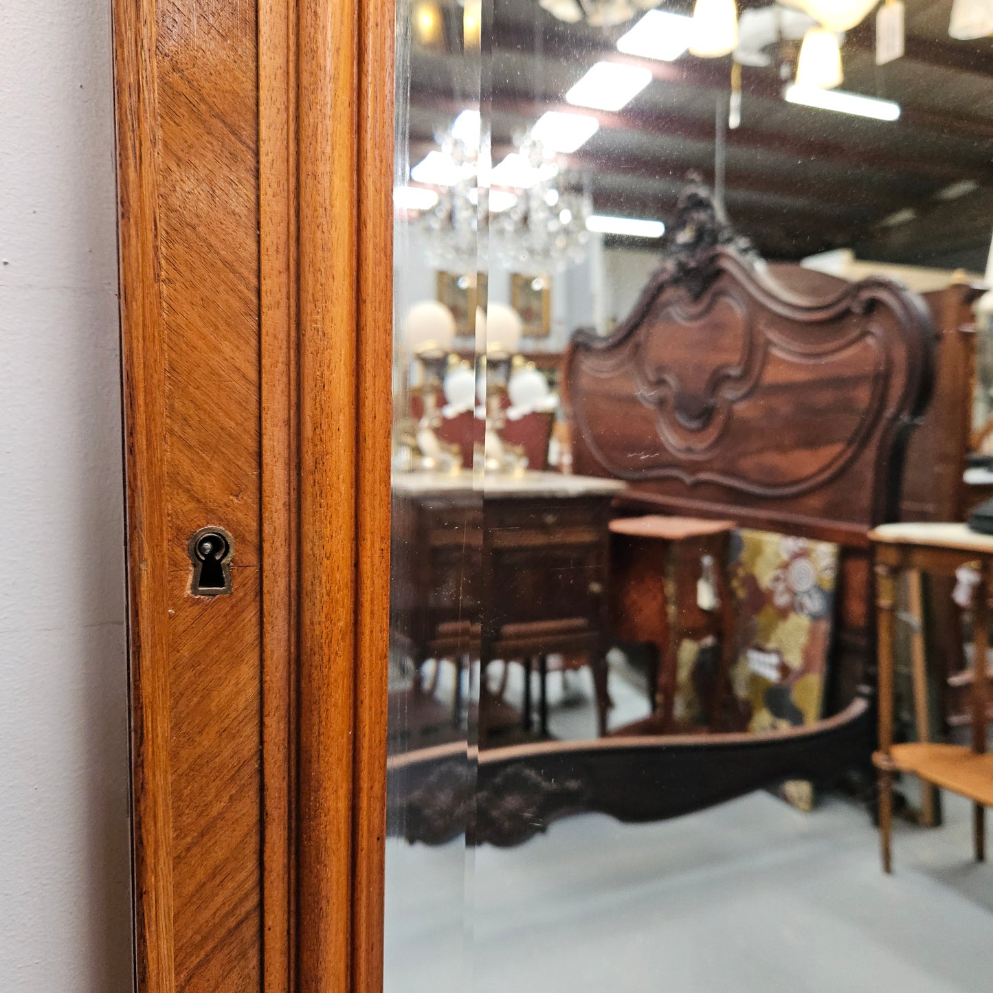 A fabulous tall Louis XV style Walnut floor/mantle mirror featuring decorative bronze gilt ormolu mounts. It still contains its beautiful original bevelled edged mirror. It has been sourced from France and is in good original detailed condition.