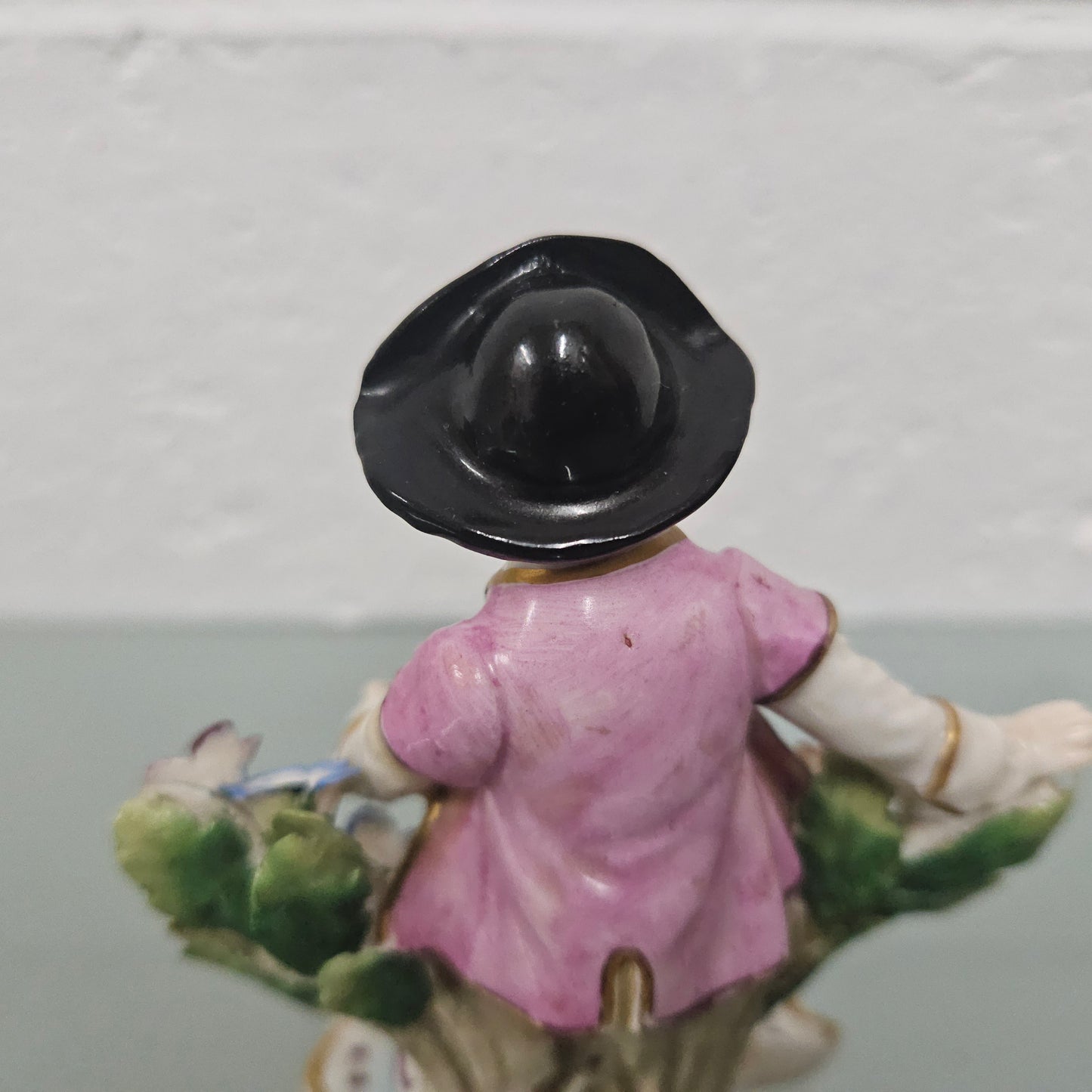 Stunning detailed early figure of a boy with flowers, there is a gold anchor mark to the back of the statue. It is in good original condition with some missing parts on the flowers as