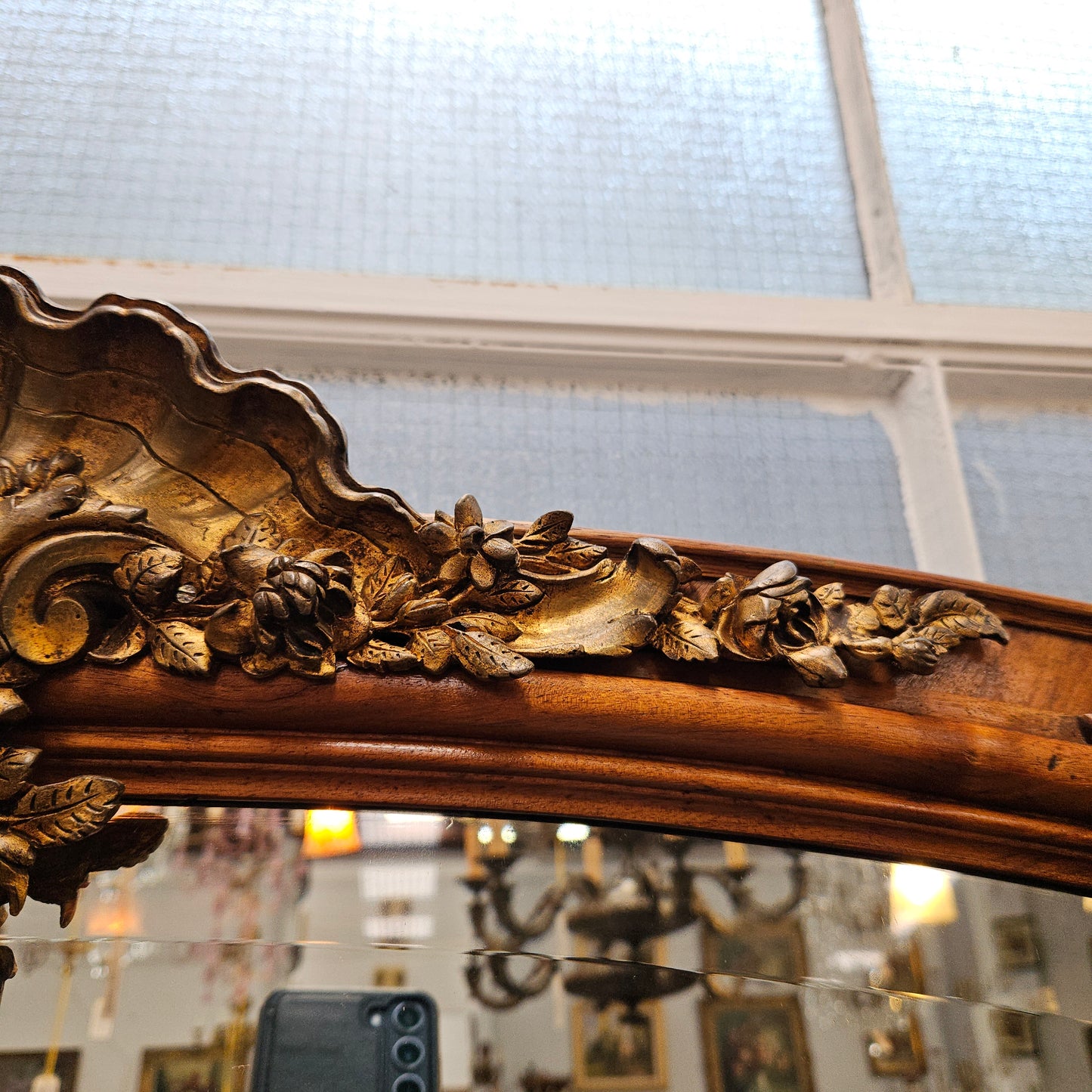 A fabulous tall Louis XV style Walnut floor/mantle mirror featuring decorative bronze gilt ormolu mounts. It still contains its beautiful original bevelled edged mirror. It has been sourced from France and is in good original detailed condition.