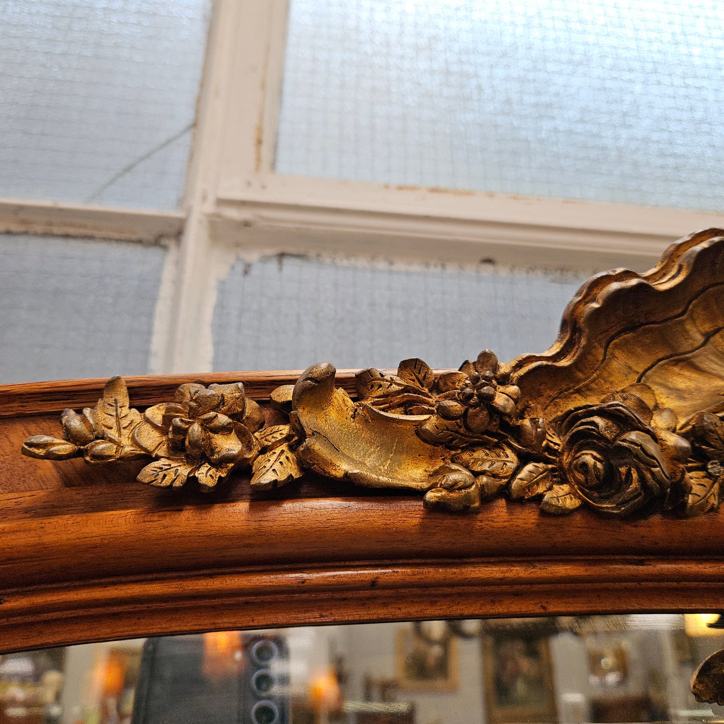A fabulous tall Louis XV style Walnut floor/mantle mirror featuring decorative bronze gilt ormolu mounts. It still contains its beautiful original bevelled edged mirror. It has been sourced from France and is in good original detailed condition.