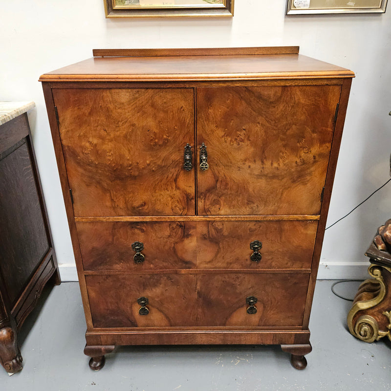 Lovely figured walnut Antique cabinet with a two door cabinet and two drawers. Circa 1930s. This cabinet can be used as a regular cabinet, drinks cabinet or tv unit as it has the hole for cables at the back. It is in good original detailed condition.
