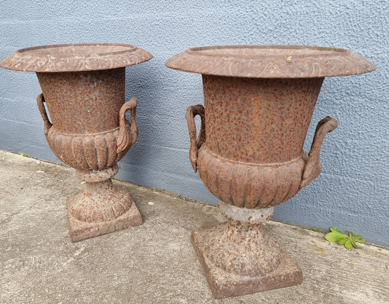 Beautiful pair of French rustic cast iron urns with handles. They would look fabulous in the garden or inside. They are very heavy an in good original condition.