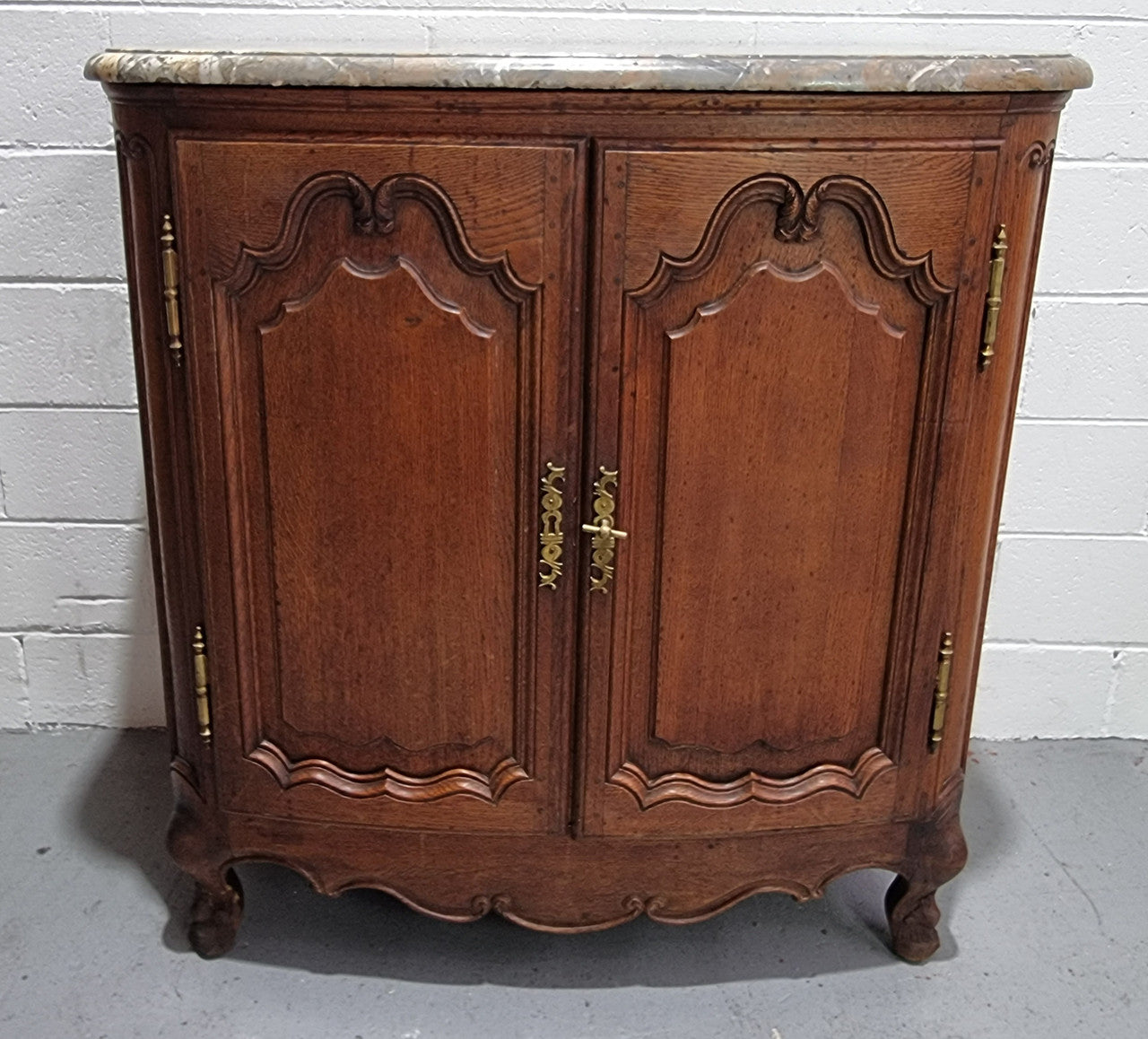 Rare 19th Century French Oak and marble top oval buffet / cabinet. Stunning thick marble top and decorative handles. In good original detailed condition.
