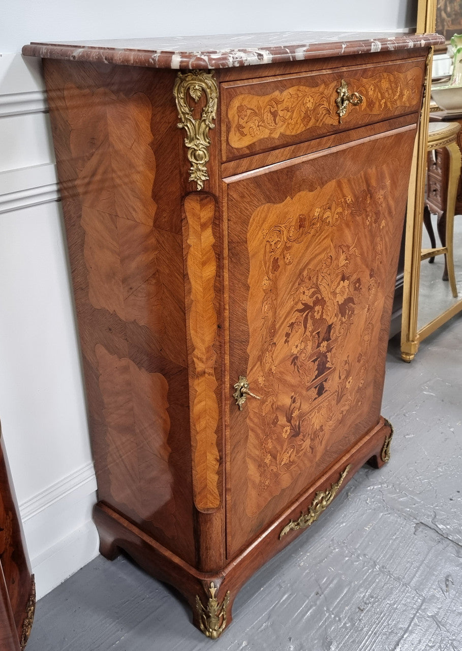 Elegant French transitional style Walnut & Kingwood Salon cabinet. It has beautiful marquetry inlay, a marble top and decorative ormolu mounts. Sourced From France and is in good original detailed condition.