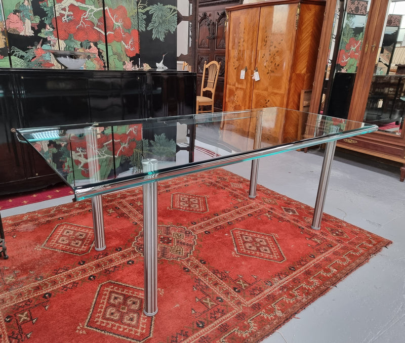 Striking and distinctive Vintage FIAM Italia Designer curved edge glass desk. FIAM was founded in 1973 by Vittorio Livio and has become synonymous with glass culture in Italy and the World. FIAM is still manufacturing today, in collaboration with various Designers, and has won numerous awards and is represented in various international museums. 
Condition: Evidence of use with minor scratches to the surface and a small chip that has been repaired. Overall, in very good condition with one repaired chip to t