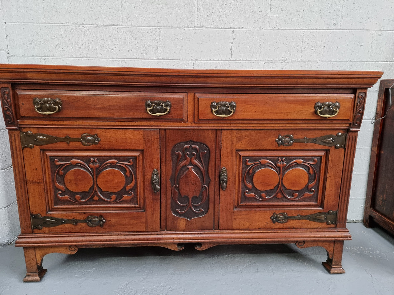 Beautiful decorative Art Nouveau sideboard with lovely handles and beautiful carved detailing. It is in good original detailed condition.