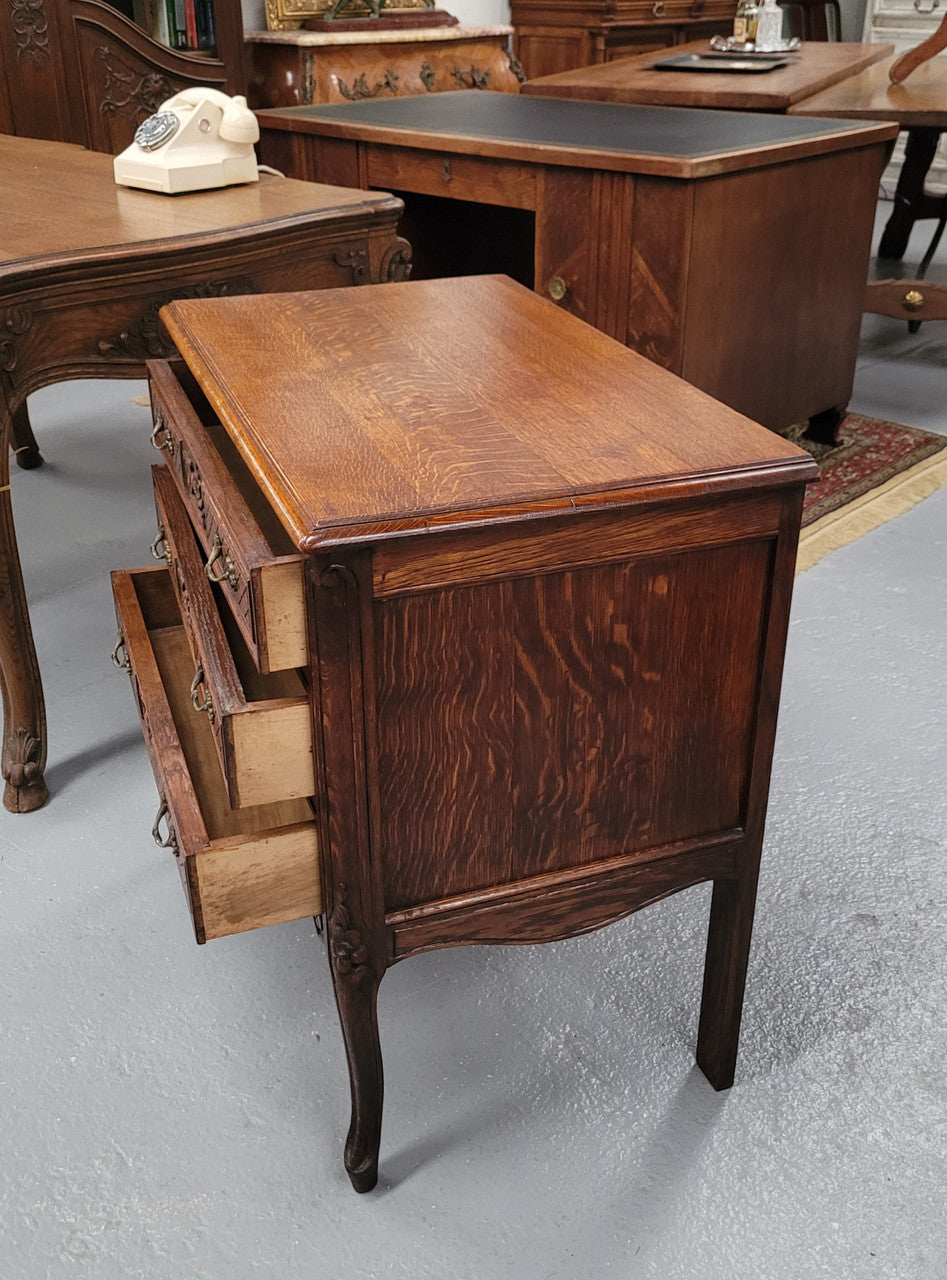 Rustic Louis XV style Oak petite three drawer chest featuring attractive carvings. It has been sourced locally and it is in good original detailed condition.