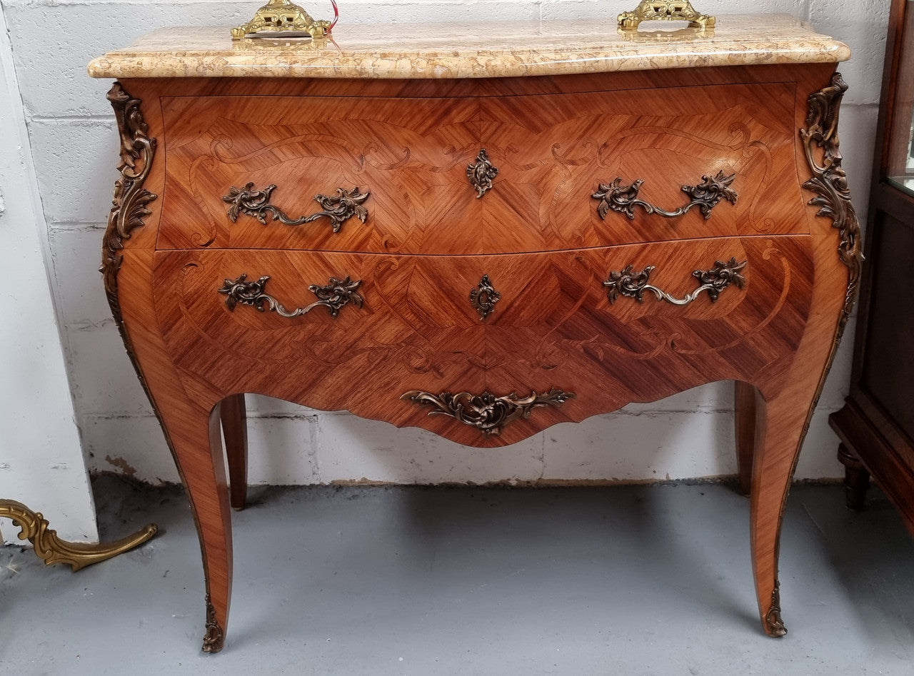 French marquetry inlaid Kingwood marble top commode. It has two drawers and beautiful mounts. Is in good original detailed condition.