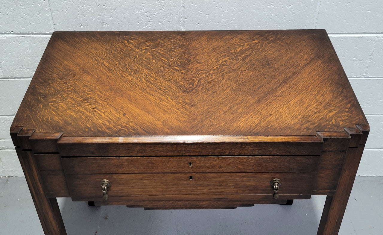 English Oak beautifully fitted cutlery table with a lift up top and drawer. Contains extensive silver plate part cutlery service by Elkington. In good original condition.