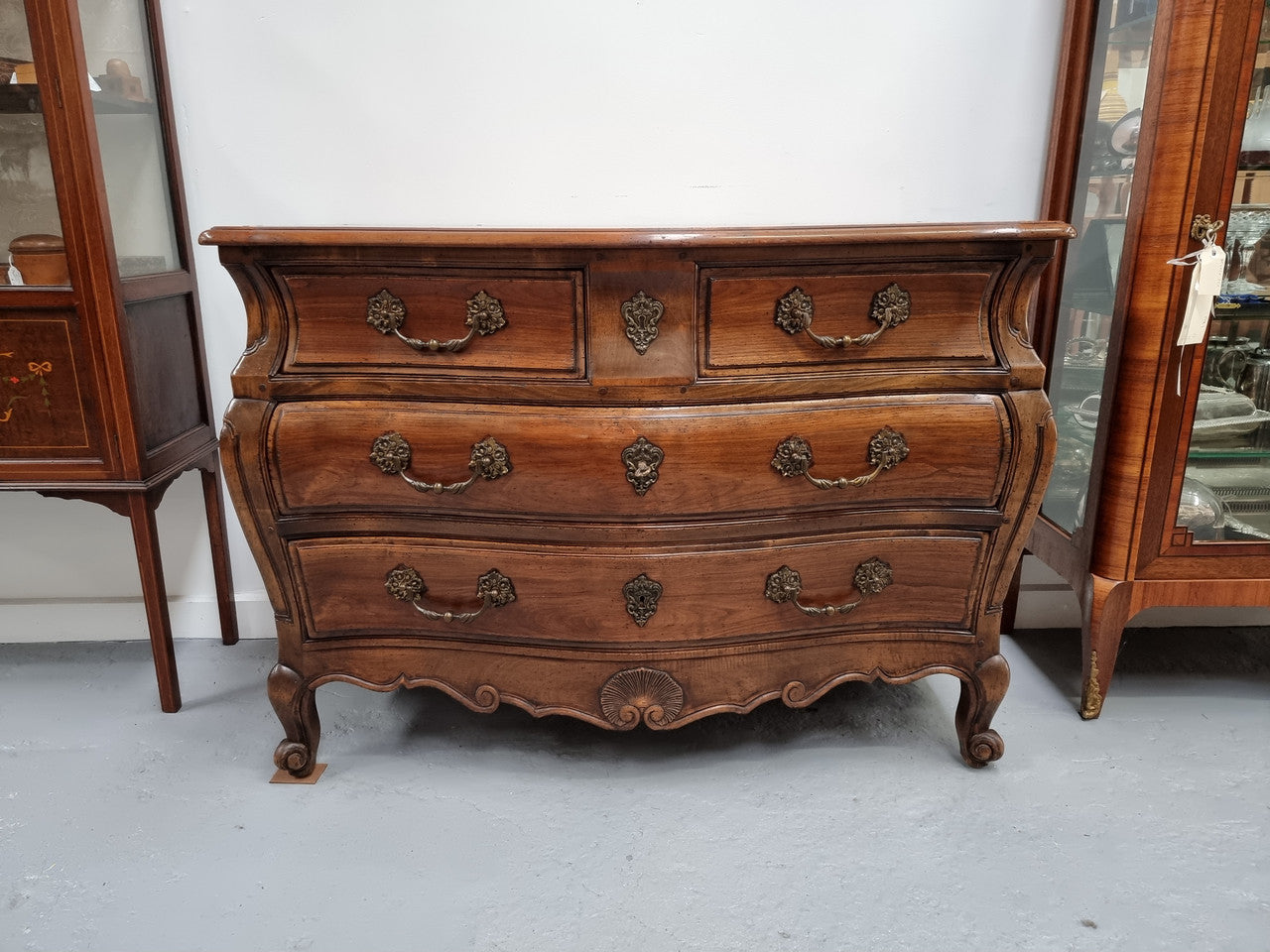 Rare wooden top Walnut Louis XV style three drawer bombe commode. Beautifully carved and is in good original detailed condition.