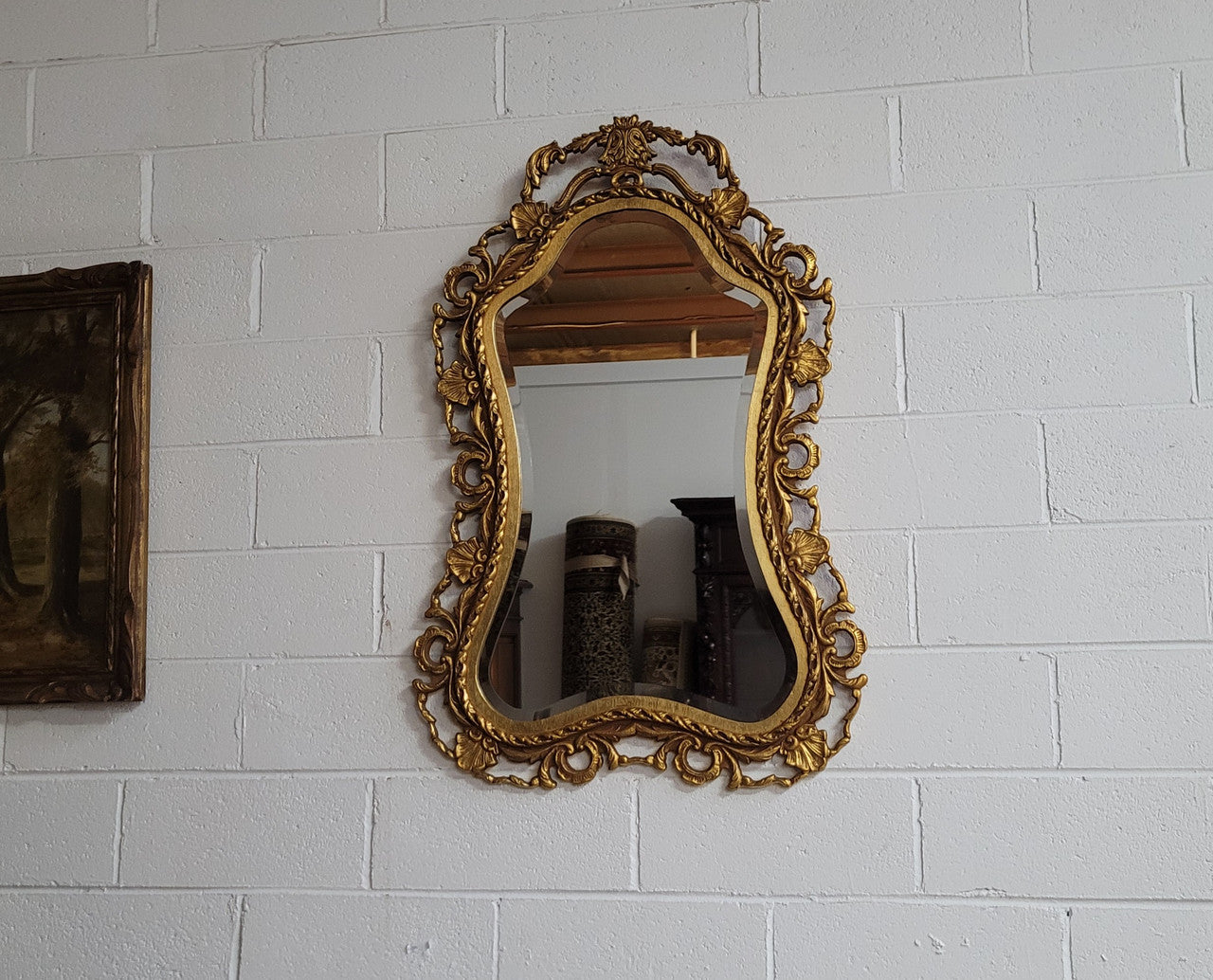 Large Vintage Italian carved wood gilt mirror. It has a beautiful bevelled mirror and has been sourced from France. It is in good original condition.