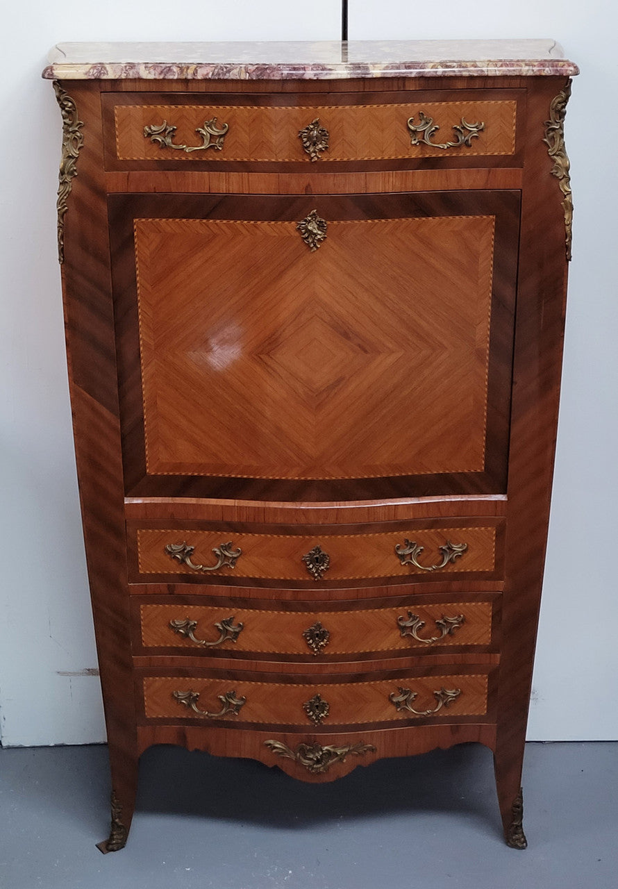 Walnut Louis XV style marble top abbattant with beautiful parquetry inlay and ormolu mounts. It has plenty of storage space with four large drawers and four smaller internal drawers. Beautiful drop down desk with a leather insert. In very good original detailed condition.
