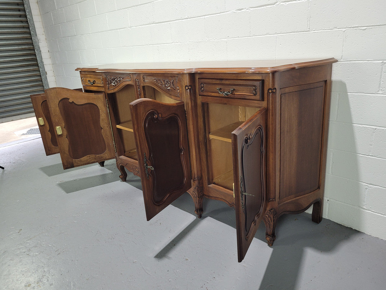 Walnut Louis XV style parquetry top four door sideboard with beautiful carving. Plenty of storage space and it is in good original detailed condition.