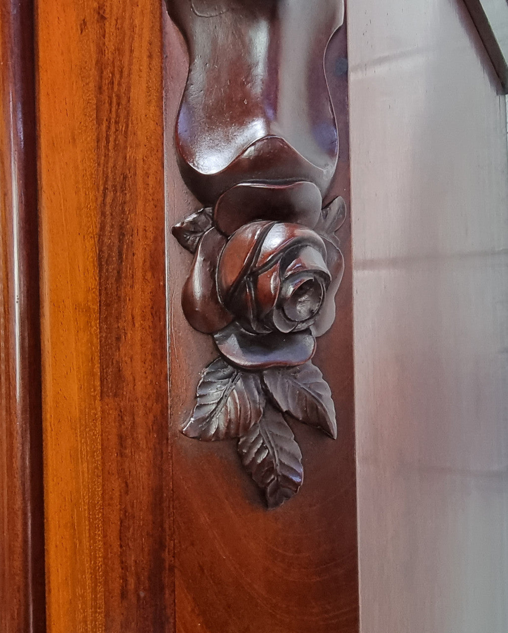 Antique Mahogany two door Biedermeier style bookcase with four fully adjustable shelves and a drawer at the bottom. The two wooden finials at the top are easily removed for a different look of desired. In good original detailed condition.