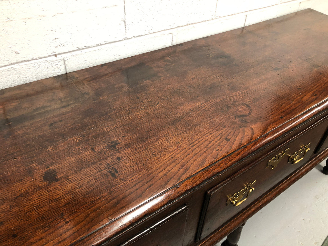 Early 19th Century English Oak dresser base with three large drawers. In very good original detailed condition.