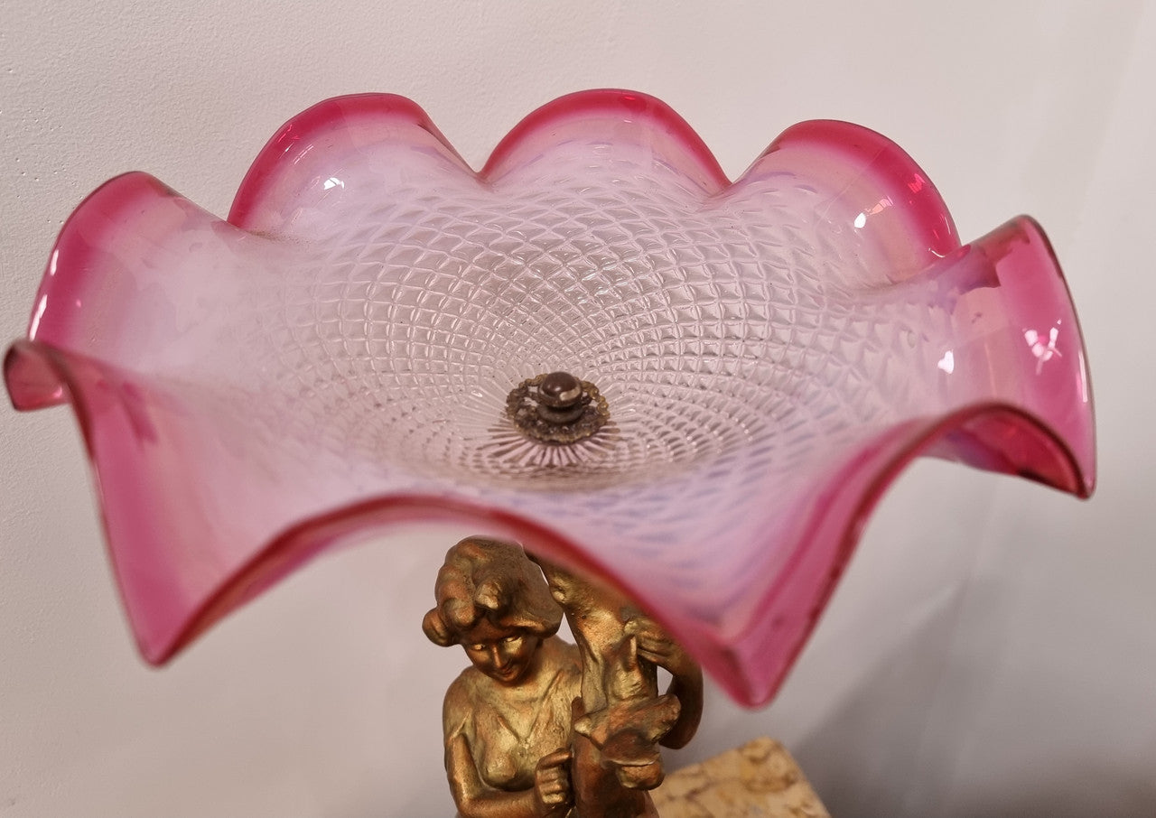 Late Victorian spelter table Centerpiece/comport featuring a woman holding an opalescent and ruby glass bowl. In good original condition with no damage to the ruby bowl.