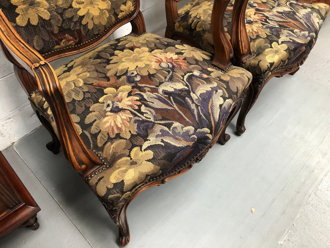 Pair of 19th Century French walnut tapestry covered arm chairs. They are in good original condition. Circa 1890.