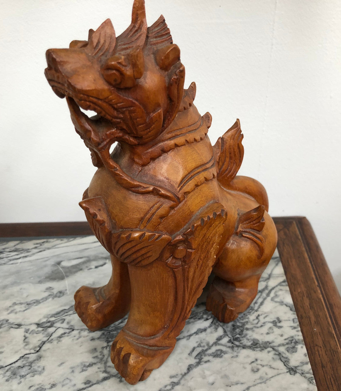 Chinese carved Teak Foo dog with very good detail. In good original condition.