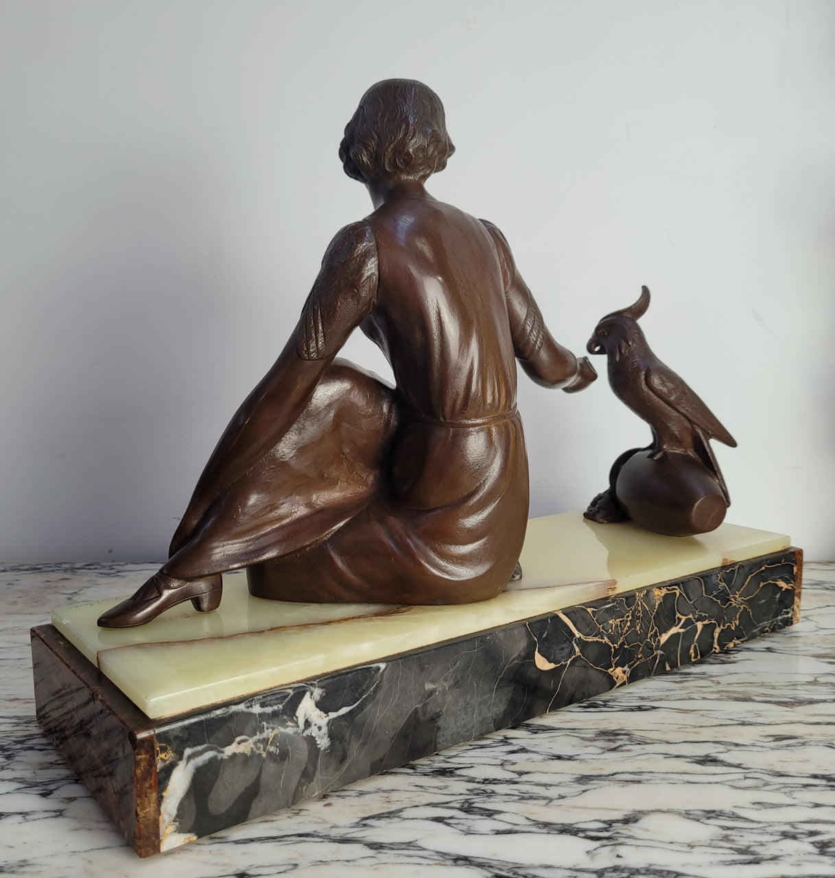 Art Deco bronze statue with brown patina of a lady and parrot on marble base. Signed by Italian Sculptor A Trefolini, an highly regarded sculptor, in very good condition.