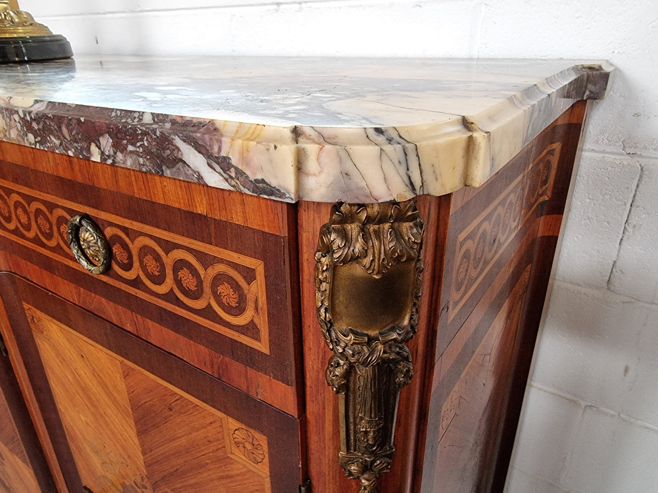 A high quality 19th Century French marquetry inlaid Kingwood marble top credenza. It has an attractive solid marble top and decorative marquetry inlay throughout. It has plenty of storage space with three drawers and three doors. It has been sourced from France and is in good original detailed condition.